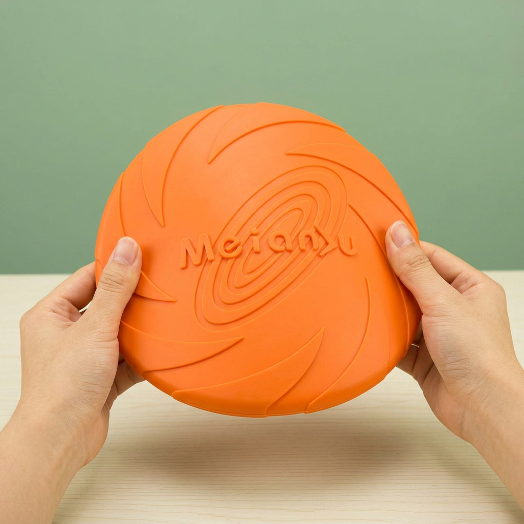 Hands gently bending an orange TPR flying disc