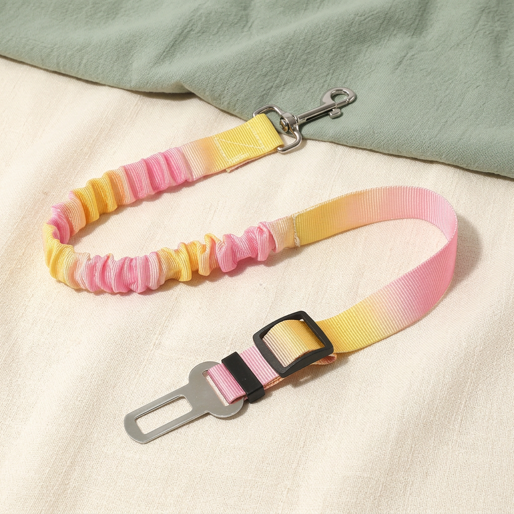 Yellow and pink dog car tether laid flat on ivory linen beside sage fabric